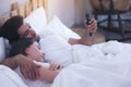 Young Couple In A Bed With Mobile Phones Royalty Free Stock Photo