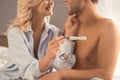 Young couple on bed pregnancy test check Royalty Free Stock Photo