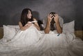 Young couple in bed scared and stressed after positive result on pregnancy test with pregnant woman expecting unwanted baby and ma Royalty Free Stock Photo