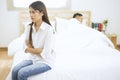 Young couple in the bedroom, The woman is sitting alone and crying, Relationship difficulties concept Royalty Free Stock Photo