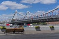 A young couple on a bench in front of the Crimean bridge in Moscow. 2018 FIFA World Cup