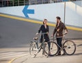 Young couple with on a bicycle opposite city