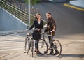 Young couple with on a bicycle opposite city