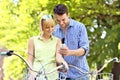 Young couple on bikes checking the cellphone Royalty Free Stock Photo