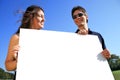 Young couple with blank sign Royalty Free Stock Photo