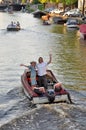 Young couple on a boat waving into the camera Royalty Free Stock Photo