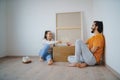 Young couple with boxes and wine moving in new flat, new home and relocation concept.