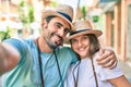 Young couple of boyfriend and girlfriend tourists on a summer trip wearing summer hat taking a selfie picture Royalty Free Stock Photo