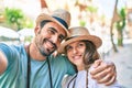 Young couple of boyfriend and girlfriend tourists on a summer trip wearing summer hat taking a selfie picture Royalty Free Stock Photo