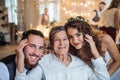 A young couple with grandmother on a wedding, looking at camera. Royalty Free Stock Photo