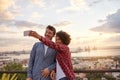 Young couple on bridge taking selfie