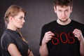 Young couple with broken heart and sos word. Royalty Free Stock Photo