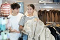 Young couple browses through luxurious fur coats