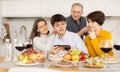 Young couple browsing photos on smartphone with elderly parents Royalty Free Stock Photo