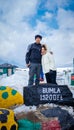 Young couple  at bumla pass india china border milestone board Royalty Free Stock Photo