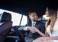 Business people shaking hands, finishing a meeting in the car Royalty Free Stock Photo
