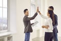 Happy couple and real estate agent making a deal and giving each other a high five Royalty Free Stock Photo