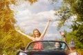 Young couple with cabriolet car in spring
