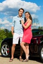 Young couple with cabriolet in summer on day trip Royalty Free Stock Photo