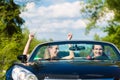 Young couple with cabriolet in summer on day trip