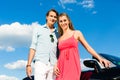 Young couple with cabriolet in summer on day trip Royalty Free Stock Photo