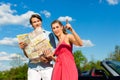 Young couple with cabriolet in summer on day trip Royalty Free Stock Photo