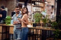 Young couple in cafe having a great time. Cheerful people, standing at the bar Royalty Free Stock Photo