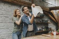 Young couple caking pizza in kitchen together