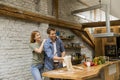 Young couple caking pizza in kitchen together