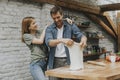 Young couple caking pizza in kitchen together