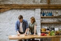 Young couple caking pizza in kitchen together Royalty Free Stock Photo