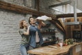 Young couple caking pizza in kitchen together