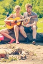 Young couple camping playing guitar outdoor Royalty Free Stock Photo