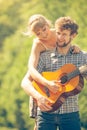 Young couple camping playing guitar outdoor Royalty Free Stock Photo