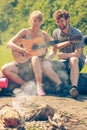 Young couple camping playing guitar outdoor Royalty Free Stock Photo