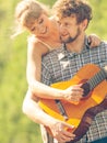 Young couple camping playing guitar outdoor Royalty Free Stock Photo