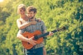 Young couple camping playing guitar outdoor Royalty Free Stock Photo