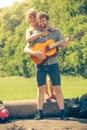 Young couple camping playing guitar outdoor Royalty Free Stock Photo