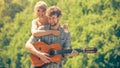 Young couple camping playing guitar outdoor Royalty Free Stock Photo