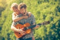 Young couple camping playing guitar outdoor Royalty Free Stock Photo