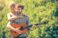 Young couple camping playing guitar outdoor Royalty Free Stock Photo