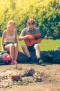 Young couple camping playing guitar outdoor Royalty Free Stock Photo