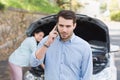 Young couple after a car breakdown Royalty Free Stock Photo