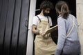 A young couple of carpenters working together in a small carpentry workshop designing a new home furniture piece crafting out of Royalty Free Stock Photo