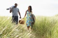 Young Couple Carrying Picnic Basket And Windbreak Royalty Free Stock Photo