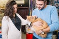 Young couple with cat in petshop