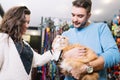 Young couple with cat in petshop