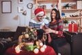 Couple celebrating Christmas at home opens gift Royalty Free Stock Photo