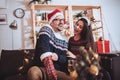 Couple celebrating Christmas at home opens gift Royalty Free Stock Photo