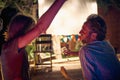 A young couple chatting while enjoying a night out in the bar at the river bank. Night, summer, bar, river Royalty Free Stock Photo